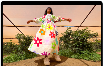 MacBook Air screen showing photo of person in colourful outfit, demonstrating colour range and resolution of Liquid Retina display