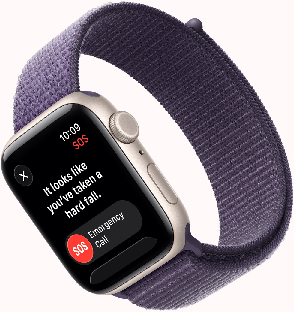 Apple Watch SE 3 med urkasse i aluminium i farven stjerneskær, SOS-notifikation fra Faldregistrering, knapperne Nødopkald og Jeg er OK, Digital Crown, mikrofon og sideknap i højre side og Sport Loop i sart lilla