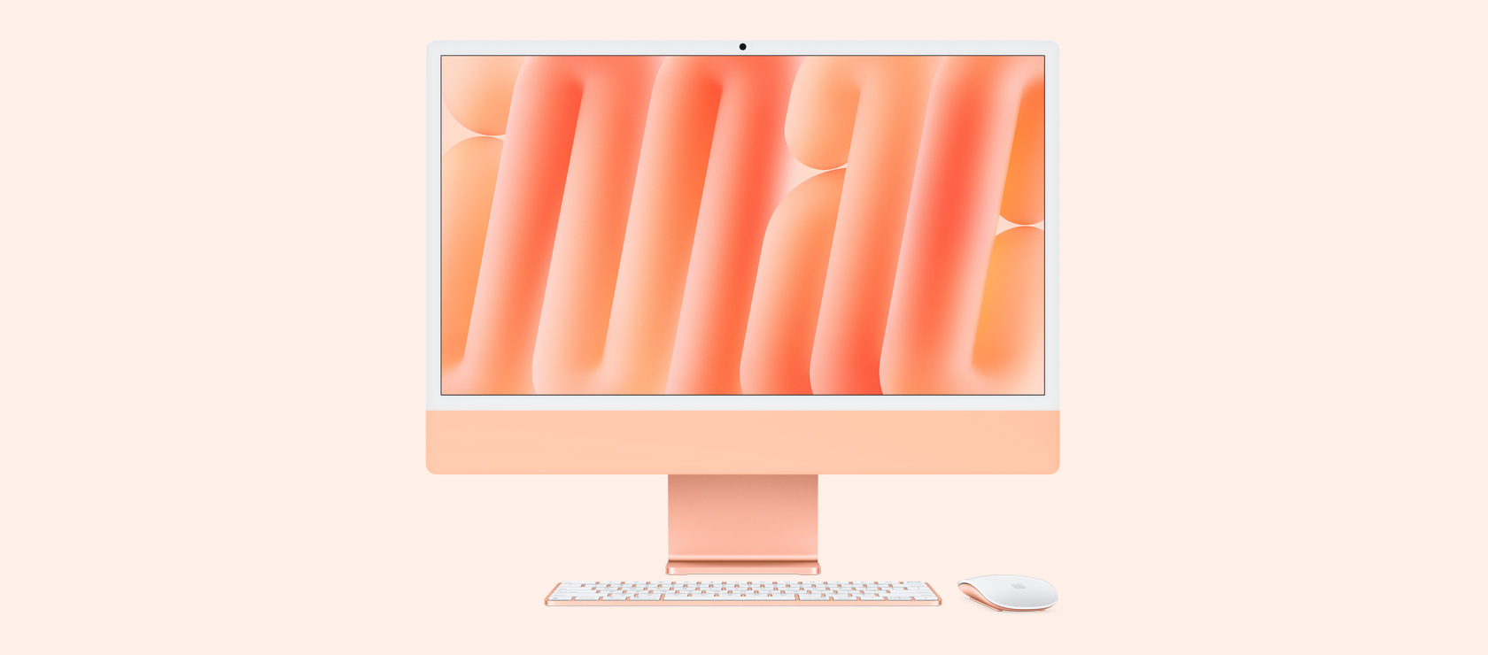 Front view of an orange iMac with colour-matching mouse and keyboard